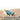 Coat Huskimo Everest Teal dog on the beach wearing huskimo dog coat