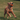 Dog running on grass with an orange toy in its mouth
